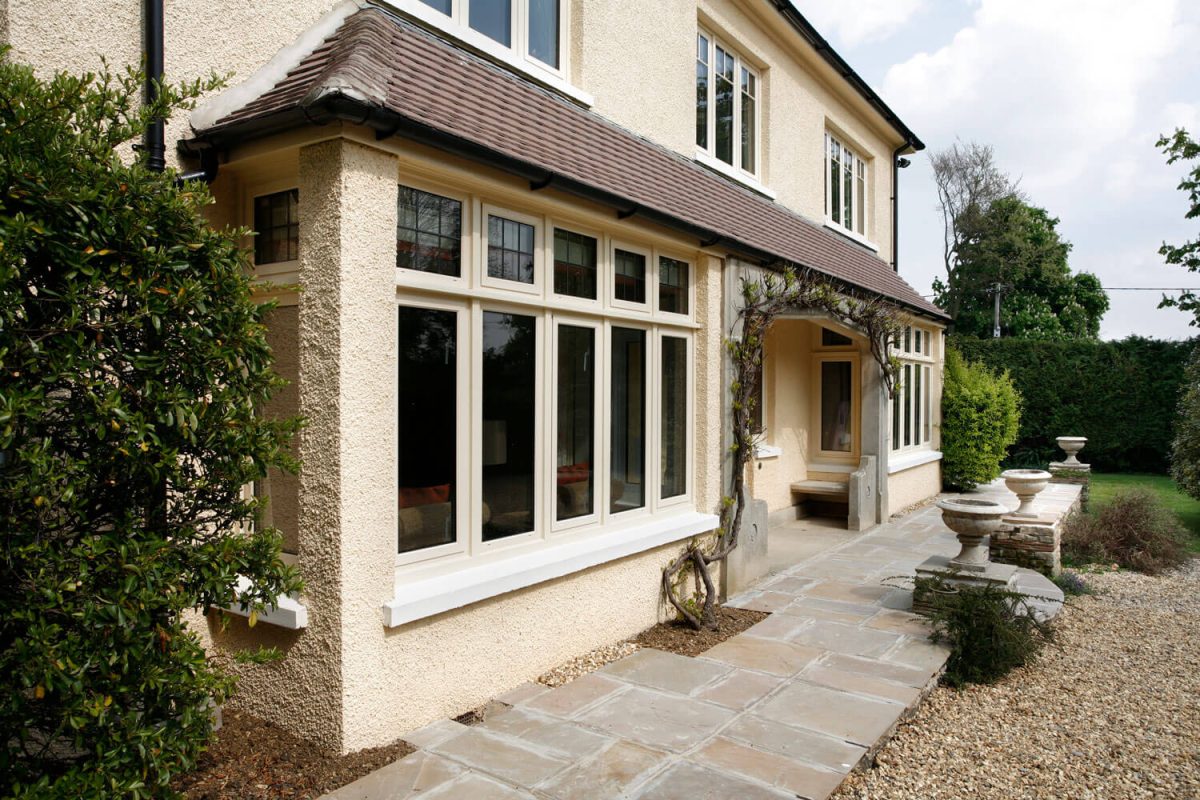 Window finance - traditional style house with large windows and front porch with front garden