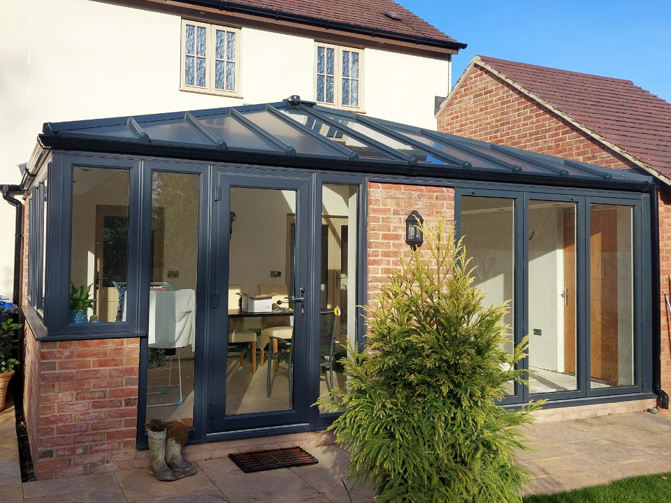 Conservatory Worcester with brick wall and dining table inside