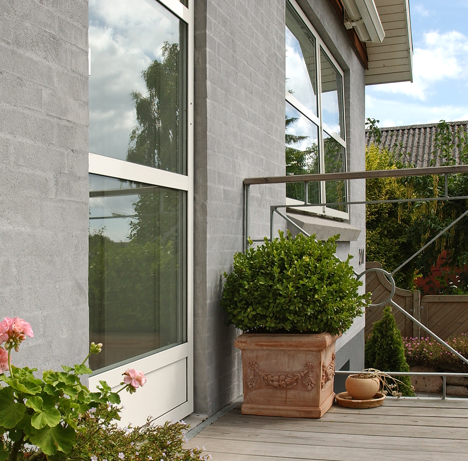 velfac 200 windows with decking outside and potted plant