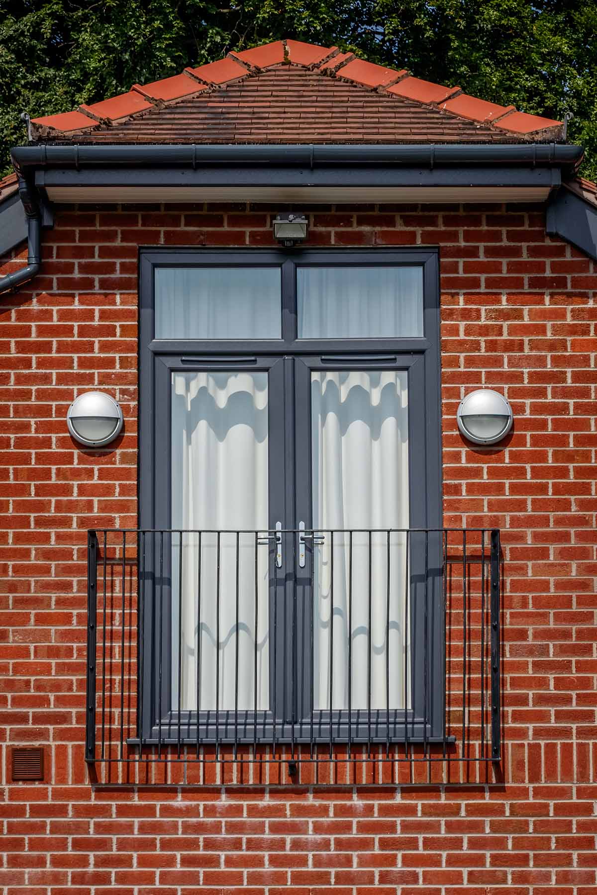 Black framed French doors Stourbridge installed on second floor with Juliet balcony